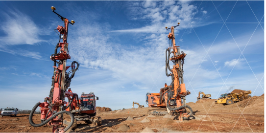 2 drillers on a dusty terrain 